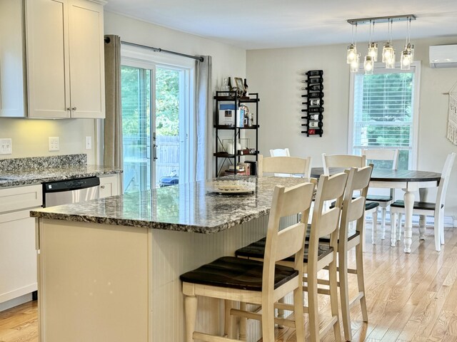 kitchen with a center island, light hardwood / wood-style floors, and white cabinetry