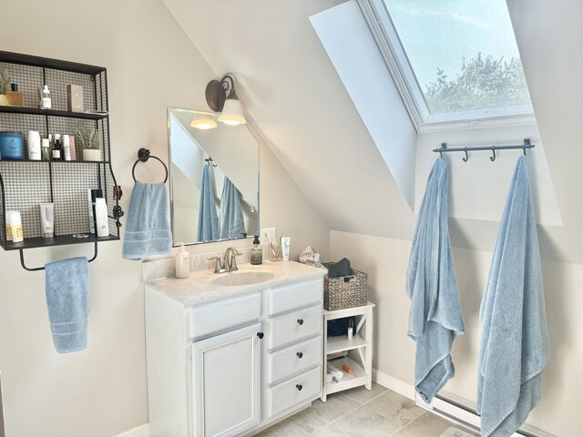 bathroom with vanity and vaulted ceiling with skylight