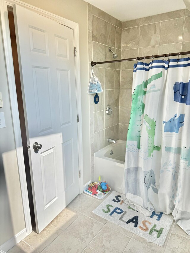 bathroom with shower / bath combo with shower curtain and tile patterned floors