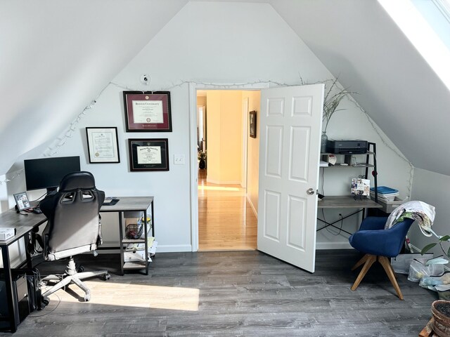 office space featuring hardwood / wood-style floors and vaulted ceiling