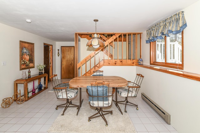 dining space with light tile patterned floors and baseboard heating