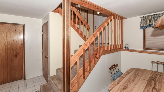 stairway featuring tile patterned flooring