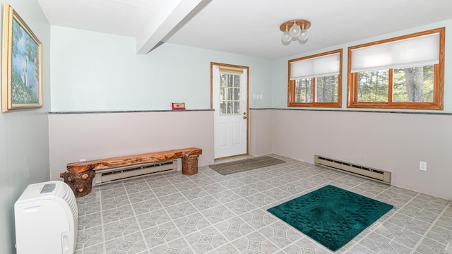 foyer entrance with beamed ceiling and a baseboard radiator