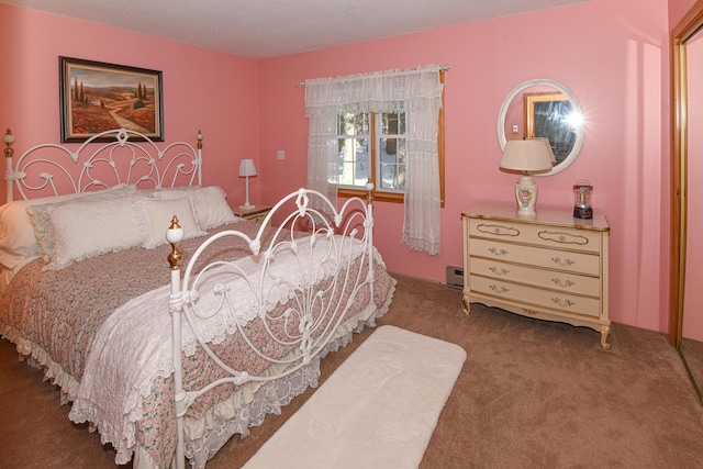 bedroom featuring a baseboard radiator, carpet floors, and a textured ceiling