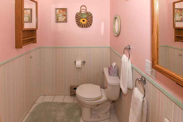 bathroom with tile patterned floors, toilet, and baseboard heating