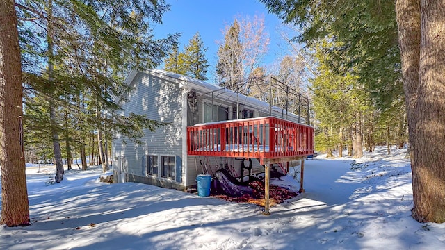 view of snowy exterior featuring a wooden deck