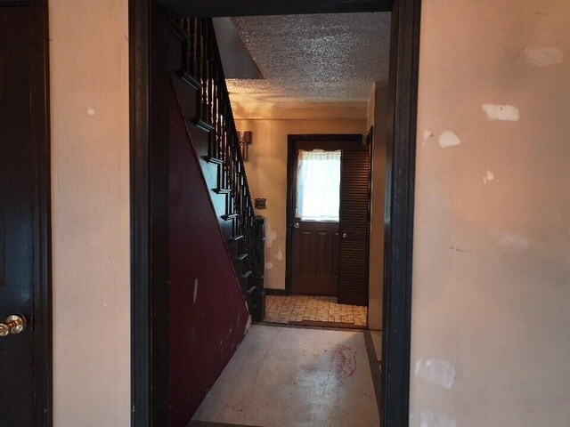 hallway featuring a textured ceiling