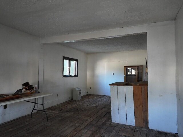 empty room with dark hardwood / wood-style flooring