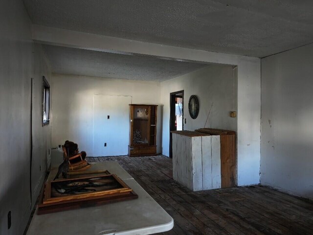 empty room with dark hardwood / wood-style flooring