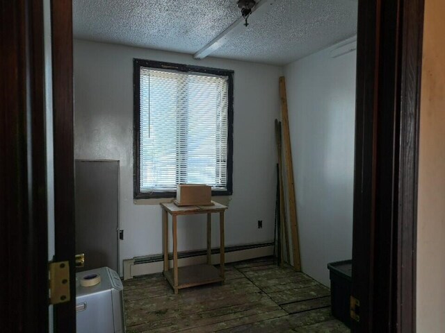 misc room with a textured ceiling and a baseboard radiator