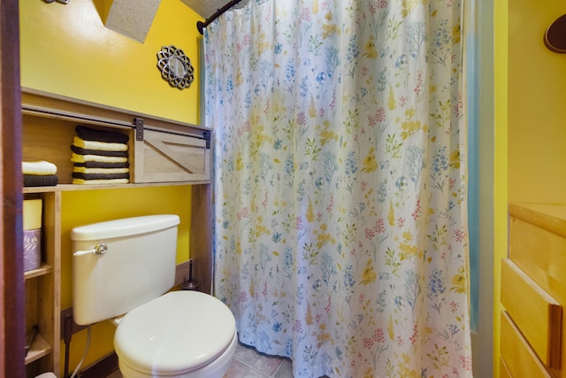 bathroom with tile patterned flooring, toilet, and a textured ceiling