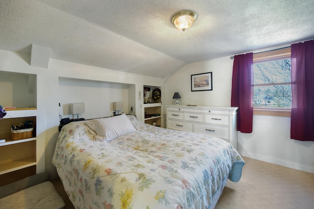 carpeted bedroom featuring lofted ceiling and a textured ceiling