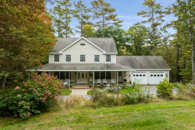 farmhouse featuring a porch, a shingled roof, a garage, driveway, and a front lawn