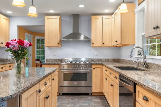 kitchen featuring light brown cabinets, wall chimney range hood, sink, high end stainless steel range oven, and black dishwasher