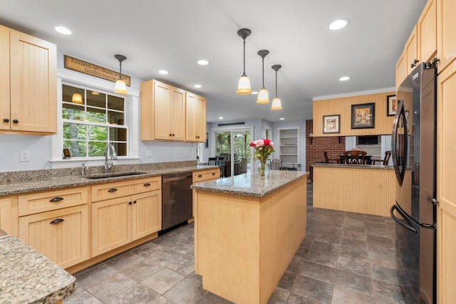 kitchen featuring light brown cabinetry, sink, a kitchen island, and black appliances