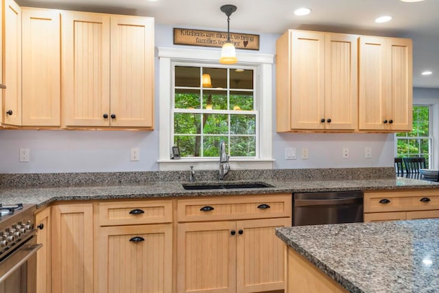 kitchen with light brown cabinetry, stainless steel appliances, pendant lighting, and sink