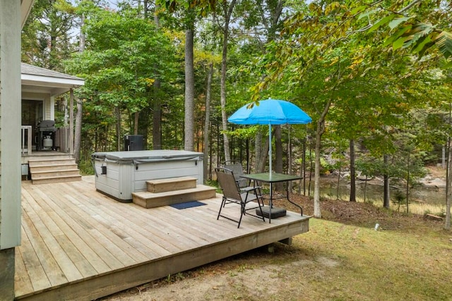 wooden deck with a hot tub