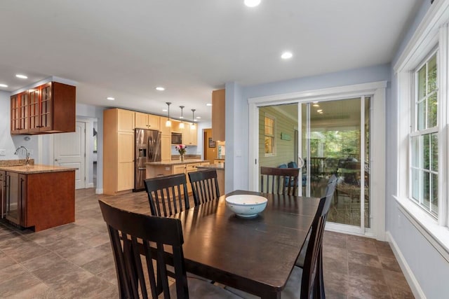 dining area featuring a wealth of natural light and sink