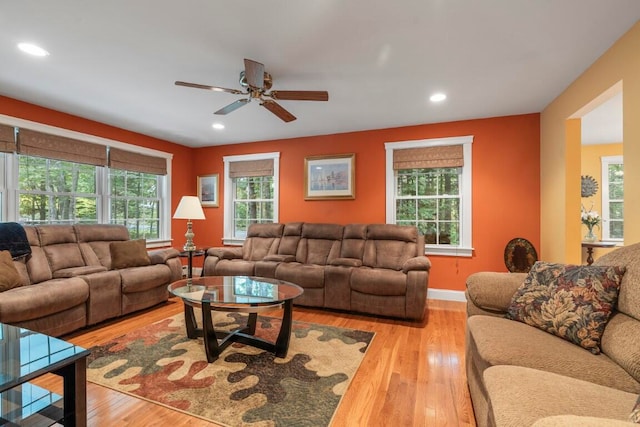 living room with light hardwood / wood-style floors and ceiling fan