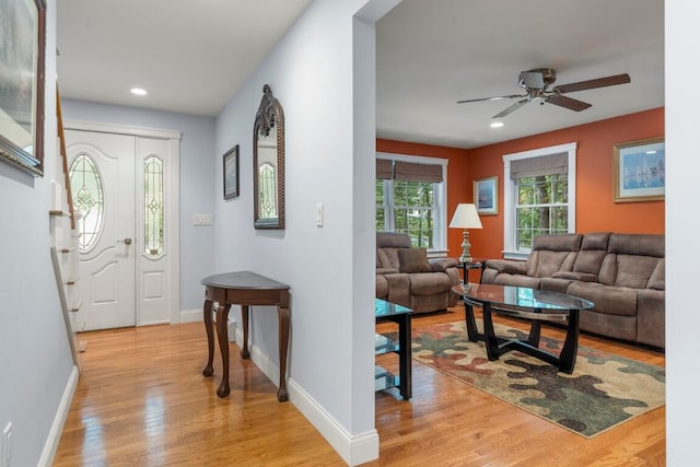 entrance foyer with ceiling fan and light hardwood / wood-style floors