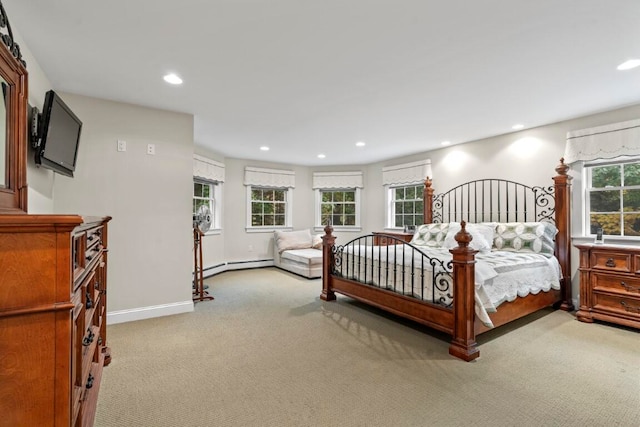 carpeted bedroom featuring a baseboard heating unit