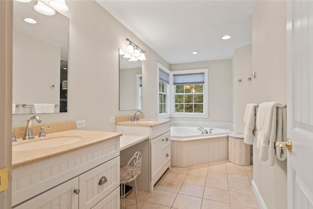 bathroom featuring tile patterned flooring, vanity, and a bathtub