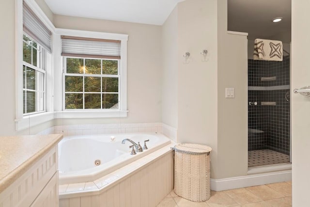 bathroom featuring vanity, tile patterned flooring, and plus walk in shower