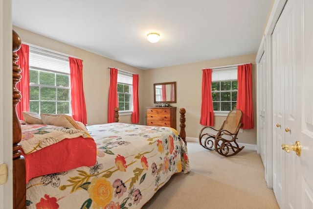 bedroom with light colored carpet and a closet