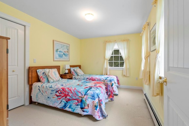 carpeted bedroom featuring baseboard heating