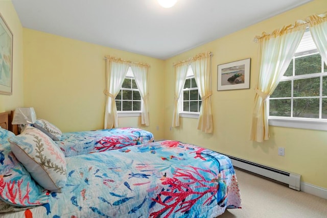 bedroom with carpet floors and a baseboard radiator