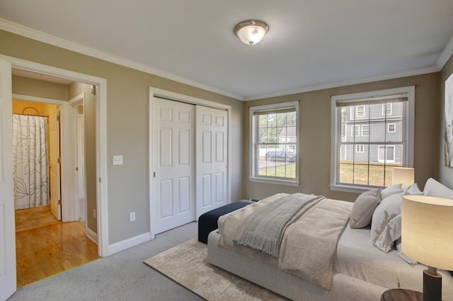 bedroom featuring a closet, light hardwood / wood-style floors, and ornamental molding