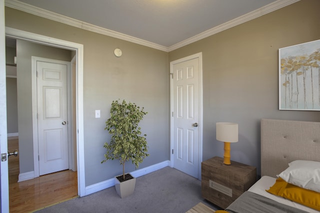 bedroom featuring crown molding and light carpet