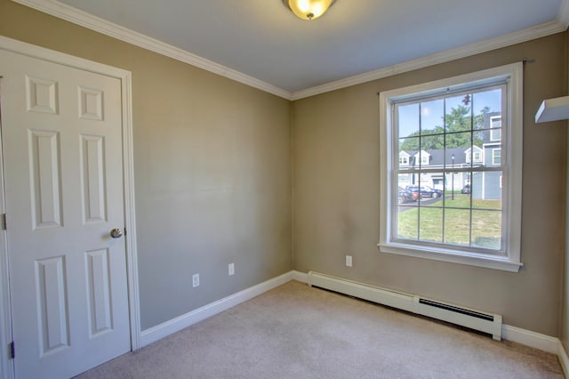 carpeted empty room featuring ornamental molding and a baseboard heating unit