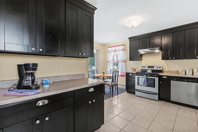 kitchen featuring stainless steel appliances and light tile patterned floors