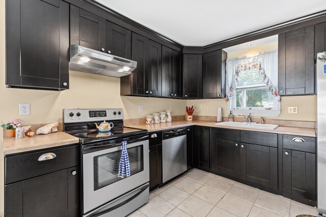 kitchen featuring light tile patterned floors, sink, and appliances with stainless steel finishes