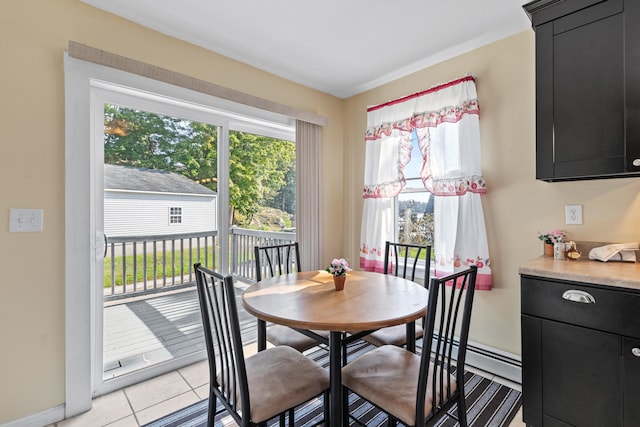 dining area featuring baseboard heating and light tile patterned floors