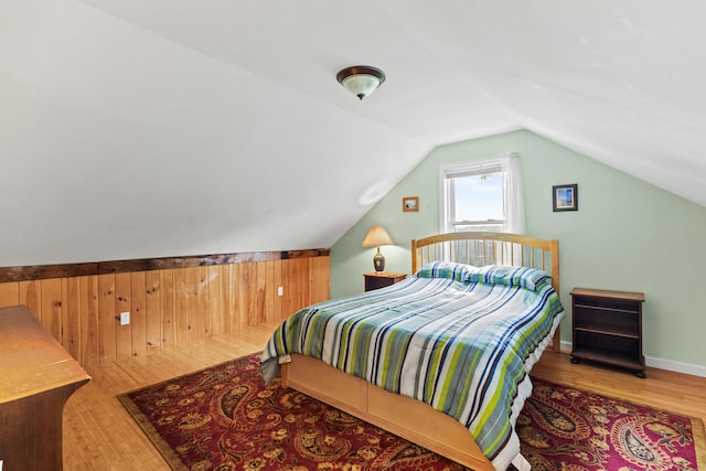 bedroom featuring lofted ceiling and wood-type flooring