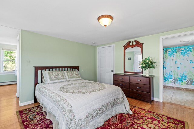 bedroom featuring light hardwood / wood-style floors and baseboard heating