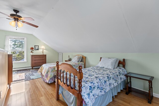 bedroom with ceiling fan, wood-type flooring, a baseboard heating unit, and lofted ceiling