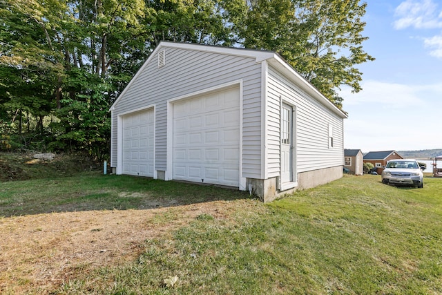 garage featuring a lawn