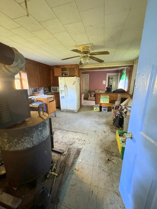 interior space with ceiling fan