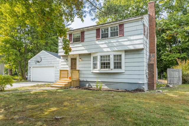 colonial home featuring an outdoor structure, a garage, and a front yard