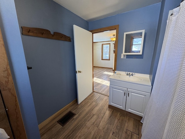 bathroom featuring hardwood / wood-style flooring and vanity