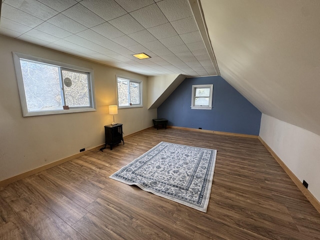 additional living space with dark hardwood / wood-style floors and lofted ceiling