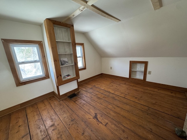 additional living space featuring hardwood / wood-style flooring, built in features, and vaulted ceiling