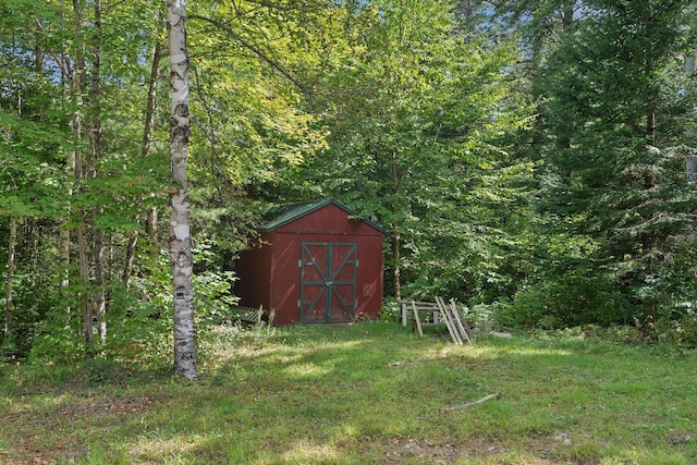 view of outdoor structure with a lawn