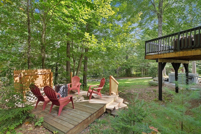 view of yard with a wooden deck and an outdoor fire pit