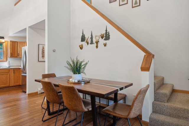 dining room featuring light hardwood / wood-style floors and a baseboard heating unit