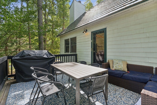 wooden terrace featuring outdoor lounge area and a grill