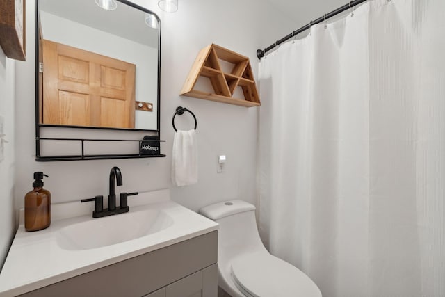 bathroom featuring vanity, toilet, and a shower with shower curtain